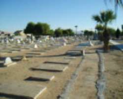 Many graves in the cemetery have crumbling cement slabs in rows Many graves in the cemetery have crumbling cement slabs in rows.